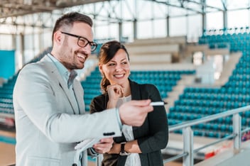 Meeting in a sport hall. Business men and woman in a sport stadium.