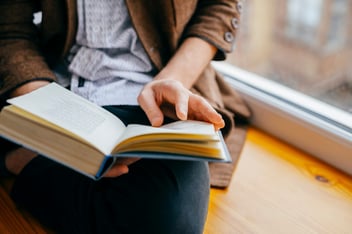 closeup of young person reading a book